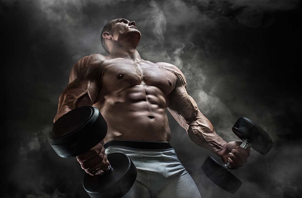 This image has an empty alt attribute; its file name is bodybuilder-doing-curls.jpg